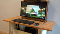 When opened, the desk has a full computer and a monitor mounted under the table top.