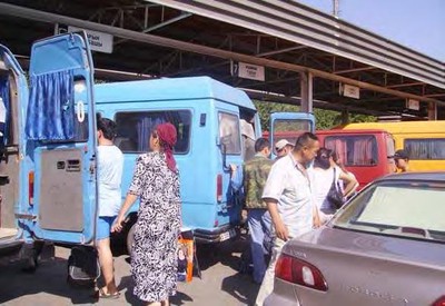 A bus depot in Bishkek, Kyrgyzstan with marshrutkas and car taxis.