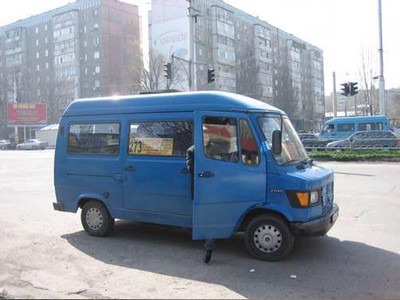 A marshrutka making a roadside stop in Bishkek.  There may be informal stops without official signage.