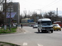 A marshrutka enroute in Bishkek, Kyrgyzstan.  The route number, 243, and a list of destinations is posted in a placard in the front and side windows.