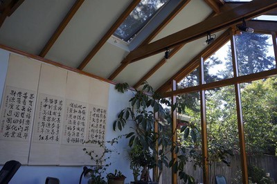 The back roof is shingled but contains openable skylights to allow for venting and thermal management.