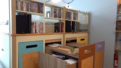 The height of the bed further separates the bed from the rest of the studio space and provides ample storage.